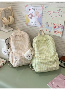 School desk setting showing plaid backpacks with lace trim and plush bunny charms
