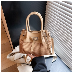 Detail of a two-tone handbag with khaki leather upper and straw woven bottom texture
