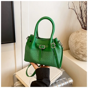 Detail view of bright green handbag with smooth leather top and woven texture bucket base