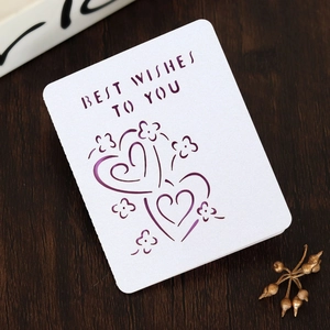Close-up of laser-cut Best Wishes greeting card with purple floral heart on wood
