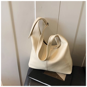 Detail shot of the cream white hobo bag showing pleated PU leather texture and strap
