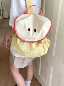 Cute apple-shaped colorful backpack for students in yellow and cream nylon with red piping