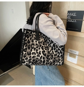 Detailed shoulder view of a large leopard print tote bag in grey and black fabric