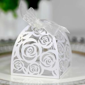 Detailed laser-cut rose pattern on white pearlescent wedding favor box with ribbon bow