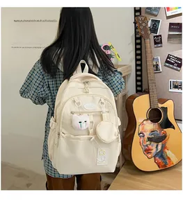 Minimalist beige waterproof backpack with plush cat charm and multi-pocket design detail