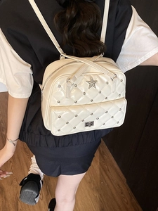 Chic beige quilted leather backpack with silver rivets and rhinestone star detail