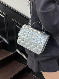 Silver quilted chain bag with rhinestone star detail and metallic finish crossbody style