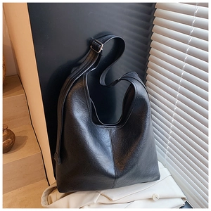 Detail of black large-capacity hobo bag with vintage crinkled leather texture