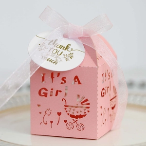 Détail de boîte cadeau rose découpée au laser avec motif landau et texte It's A Girl
