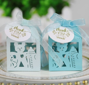Vue détaillée des boîtes à bonbons avec ours creux, rubans bleus et étiquettes merci