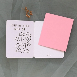 Detail of laser-cut Best Wishes card with white hollow pattern and pink inner paper