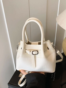 Chic cream white woven bucket bag with elegant leather buckle and adjustable strap