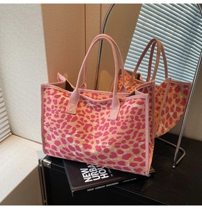 Detail of pink leopard print canvas tote bag featuring woven round handles and sturdy edges