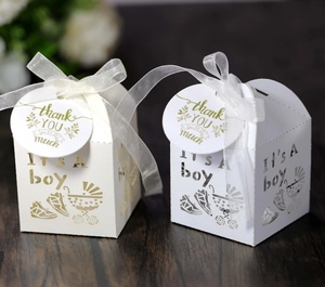 Detailed laser-cut baby shower candy box with blue ribbon and 'It's a Boy' hollow design