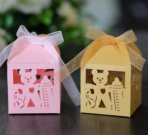 Detail of pink and gold laser-cut bear candy boxes with elegant organza ribbon bows