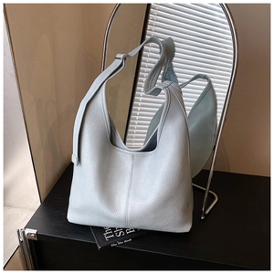 Detail of mint green hobo bag with vertical stitching and wide adjustable strap