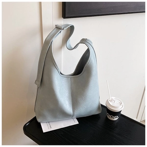Detail of light blue hobo bag showing pleated leather texture and silver buckle
