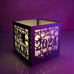 Black paper lantern featuring CLASS OF 2024 cutout with warm glowing LED light