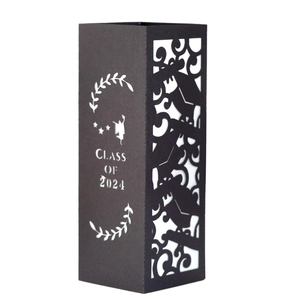 Detail of laser-cut black paper candle shade with Class of 2024 graduation silhouette