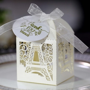 Detailed laser-cut Eiffel Tower favor box with white ribbon and Thank You tag