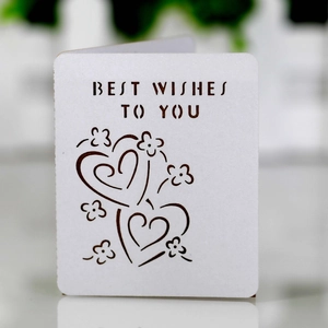 Detail of laser-cut 'Best Wishes' card featuring white floral hollow heart pattern