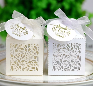 Detail of laser-cut rose gift box with white pearlescent paper and thank you tag