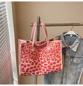 Detailed shot of pink leopard print canvas tote bag with dual handles for daily use