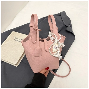 Pink bucket bag with lychee texture featuring pearl lace bow and cartoon sheep charm