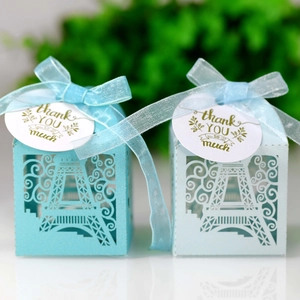 Detail of laser-cut Eiffel Tower candy boxes in light blue with thank you tags