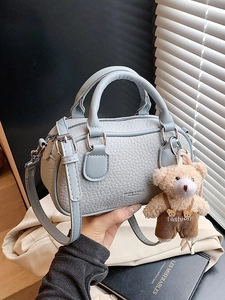 Light blue lychee pattern bowling bag with bear charm and adjustable shoulder strap