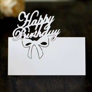 Laser cut Happy Birthday place cards in white cardstock with bow and hollow design