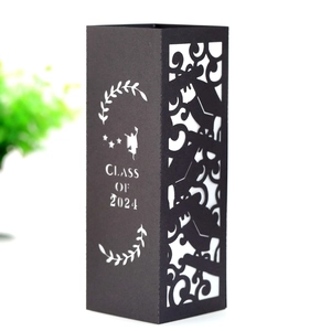 Laser-cut black paper candle shade with Class of 2024 graduate silhouette and stars