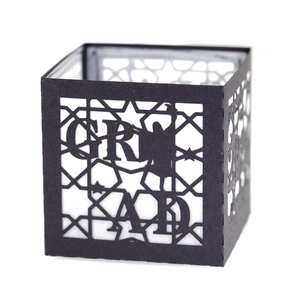 Close-up of black graduation paper gift box with laser-cut GRAD letters and silhouettes