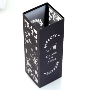 Detail of laser-cut 'Class of 2024' lettering on black paper lampshade for graduation