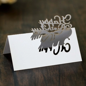 Macro view of white laser-cut Happy Birthday place card with hollow deer head detail