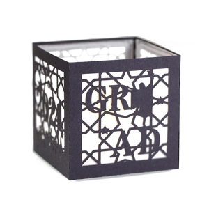 Detail of laser-cut black paper lantern with stars and 2024 graduation silhouette