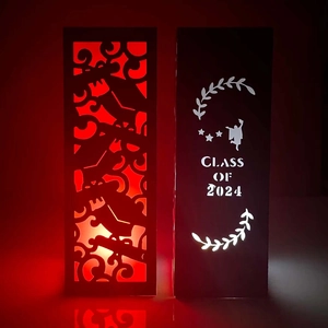 Detailed laser-cut Class of 2024 graduation paper lantern with silhouette cutout patterns