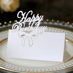 Detailed laser-cut Happy Birthday name place cards made of premium white pearlescent paper