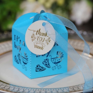 Blue baby shower candy box with laser-cut carriage design and thank you tag