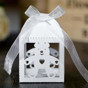 White laser-cut baby bear candy box with heart pattern and elegant silver organza ribbon