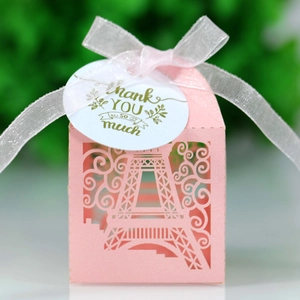 Close-up of pink laser-cut favor box with Eiffel Tower design and Thank You tag