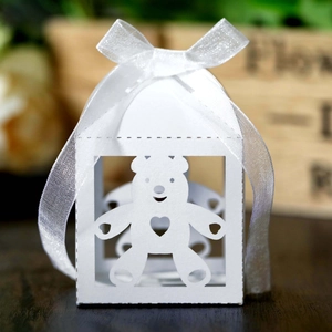 Macro view of white hollow bear candy box with delicate organza ribbon bow decoration