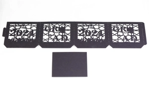 Detail of laser-cut black paper lantern wrap featuring Class of 2021 and Grad text
