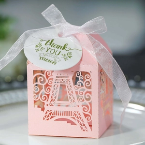 Close-up of pink laser-cut favor box with Eiffel Tower design and thank you tag