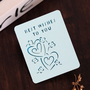 Detail of light blue laser-cut greeting card with Best Wishes to You text and floral hearts
