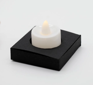 Detail of LED tea light candle with black square base for paper lantern decor