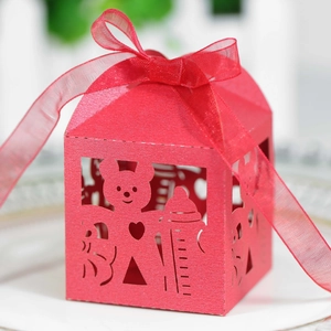 Detail showing the red laser-cut bear baby shower favor box with silk ribbon decoration