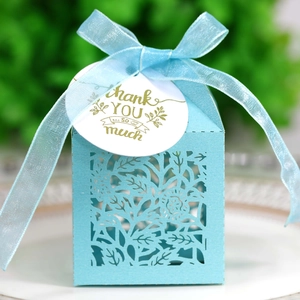 Detail of laser-cut rose gift box in light blue with sheer ribbon and Thank You tag