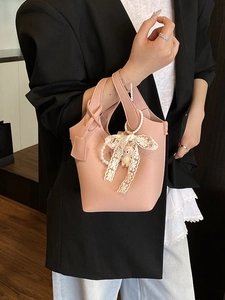 Pink lychee texture leather bucket bag with knotted handle and cute lace lamb pendant