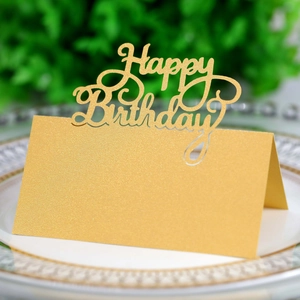 Detail of glitter gold Happy Birthday laser cut place card on white dinner plate